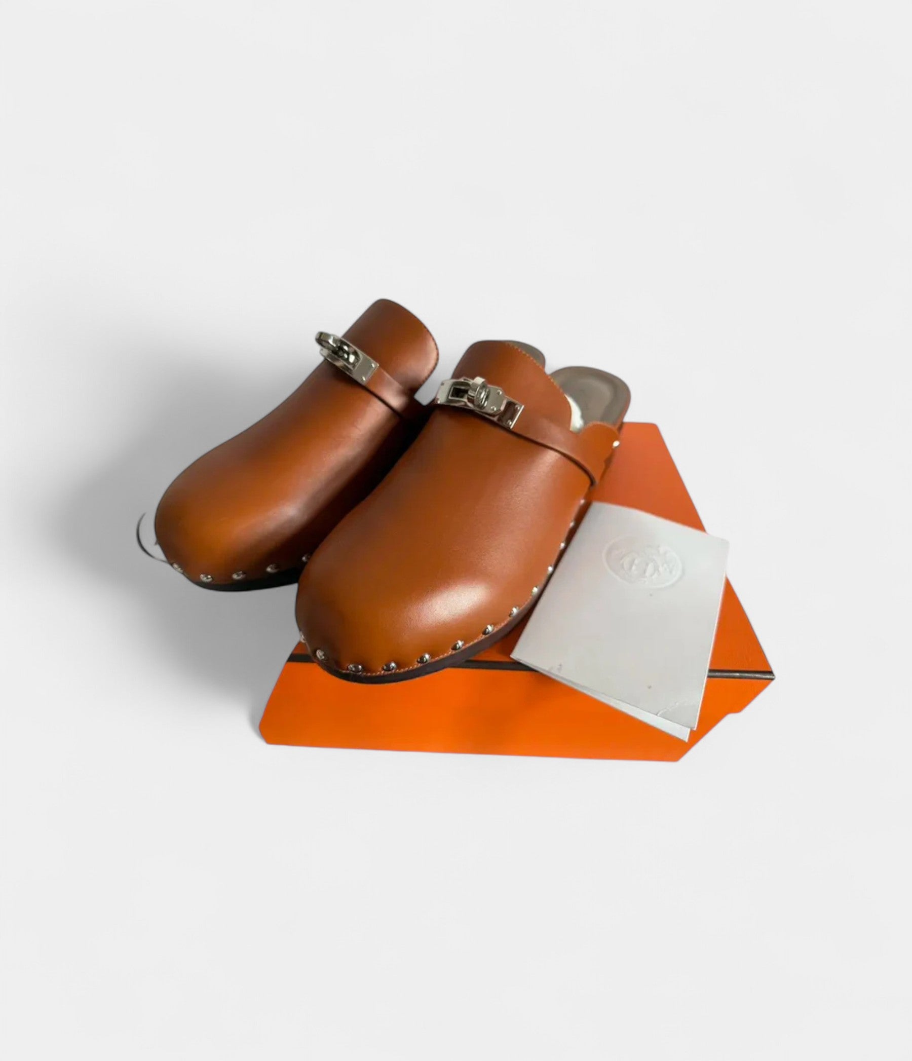 HermesCarlottaLeatherMules_ClogsTimelessComfortwithSophisticatedFlair_4_1ecc0dd1-85cd-46f3-a51e-49fd7d6da527.jpg Hermès Carlotta Leather Mules & Clogs Timeless Comfort with Sophisticated Flair